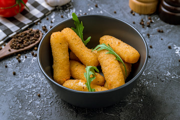 fried Cheese sticks on black plate