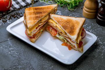 club sandwich on black concrete