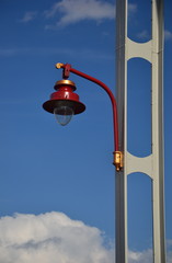 old street red lamp isolated on cloudy sky background