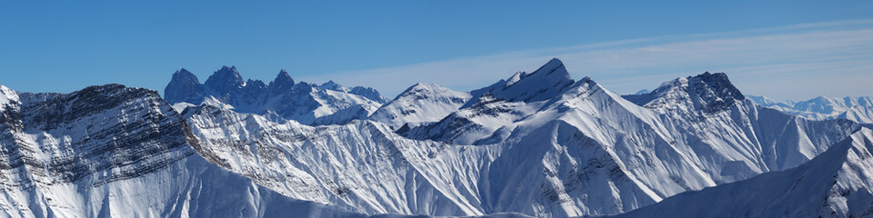 Fototapeta na wymiar Panoramic view of snowy mountains at sun winter day