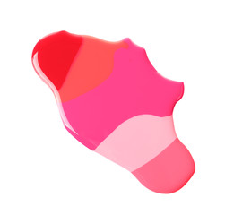 Spilled different nail polishes on white background