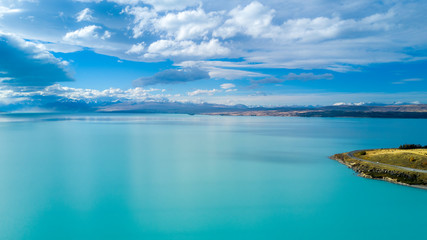 Beautiful lake on a sunny day with mountain peaks on the background. Otago, South Island, New Zealand