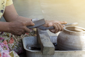  Rubber planters are cleaning and secretly cut the rubber knife for tapping rubber with selective focus.