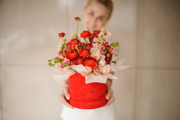 All kinds of flowers in round red hat box