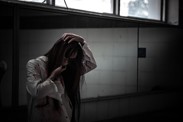 Portrait of asian woman make up ghost face with blood,Horror scene,Scary background,Halloween...