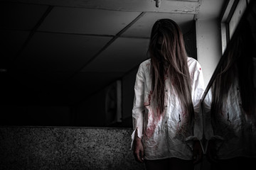Portrait of asian woman make up ghost face with blood,Horror scene,Scary background,Halloween...