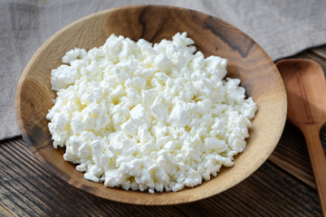 Cottage cheese in a wooden bowl. Farm products. Village Breakfast