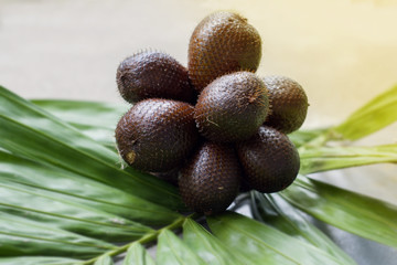   Closeup  group of Salak fruit(Salacca zalacca) is a type of palm tree and leaf with morning lighting effect.