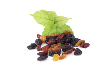 Raisins or Dried grapes mix color black, red, green with mulberry leaves isolated on white...
