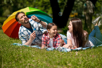 Happy family enjoying time in summer park