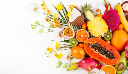 Still life with fresh assorted exotic fruits on a palm leaf.