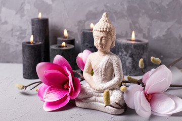 Still life with Buddha, candles and  magnolia flowers