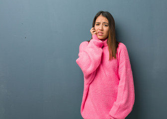 Obraz premium Young modern woman biting nails, nervous and very anxious