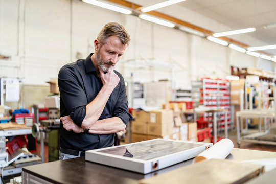 Man in factory working on solar cell