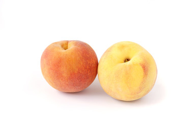 Fototapeta na wymiar Two fresh peach red and yellow fruit isolated on white background