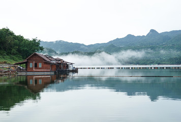 Fototapeta premium renovate, under construction wooden floating raft house resort by mountain Kanchanaburi Thailand