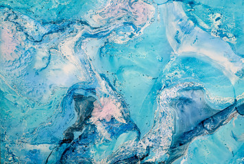 Blurred marbling in blue tones. Creative abstract background with  acrylic painted handmade surface. Liquid paint.