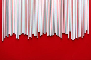 Colorful straw cocktail on red background