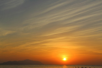 Fototapeta premium Dawn on the beach. Sun and sea in the early morning. Beautiful seascape.