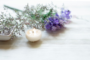 Spa setting relax composition  burning candles and lavender flowers on white wooden background ,wellness  healthy concept