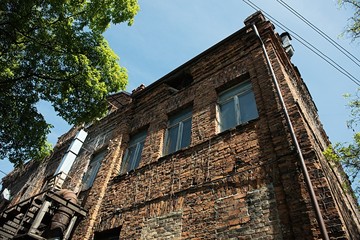 Fototapeta na wymiar Old Building. Red brick House. Blue sky.