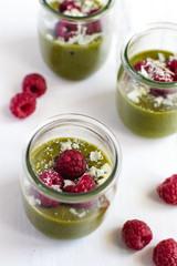 White chocolate cream mousse with matcha, avocado, pistachio, fresh raspberries - healthy vegan dairy free, gluten free