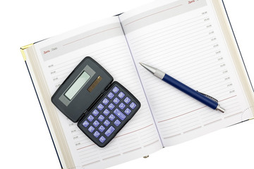 Calculator, pen and notebook on a white
