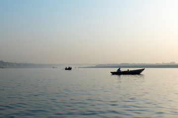 Naklejka premium Varanasi, India, 27 Mar 2019 - Dashaswamedh Ganges river ghat Varanasi at twilight with tourists enjoying boating rides