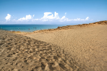 Beach background of free space and summer day. Hot yellow sand and blue sky. 