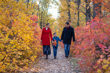 Fototapeta premium Family walking in autumn forest