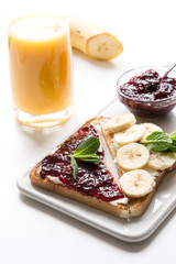 Different types of sandwiches for healthy children's breakfast without sugar, with berry jam, bananas. Close up.