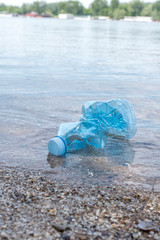 Plastic bottle in the river water as concept for pollution