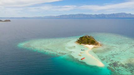 Tropical island Bulog Dos. Tourists walking along the sand bar Seascape in the tropics aerial view. Philippines, Palawan