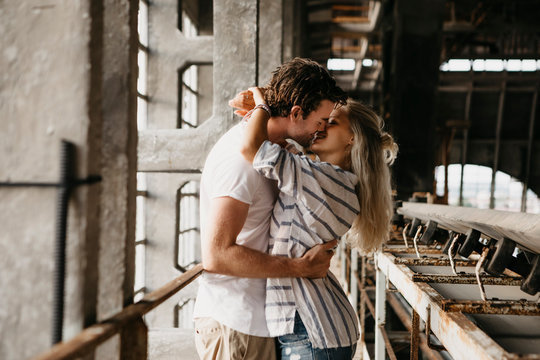 Young couple kissing in an old train station