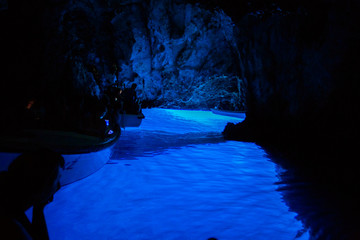 Tourists inside Blue cave, Bisevo island - Croatia. 