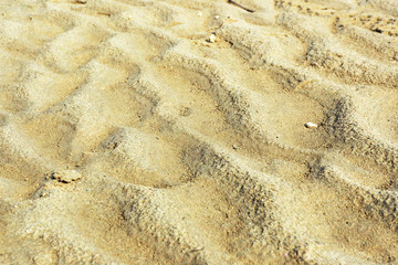 Texture and background sand on the lake in the form of waves...