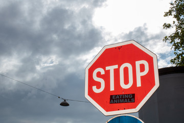 stop sign  with sticker saying 