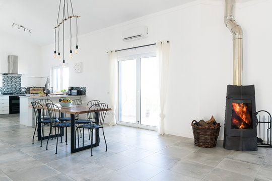 Modern dining room and kitchen with fireplace