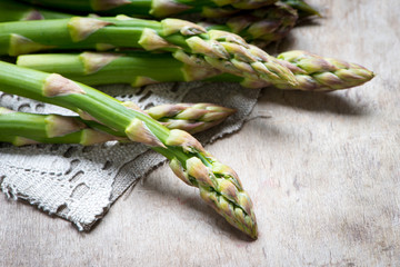 fresh green asparagus on wooden table