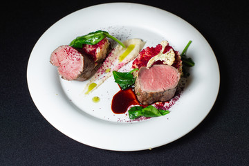 Beef steak with mashed potatoes decorated with greens on a white plate-2.