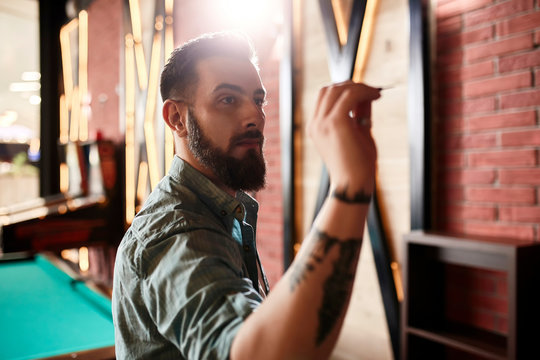 Portrait Of Man Playing Darts