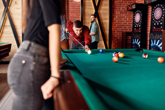Friends playing billiards together