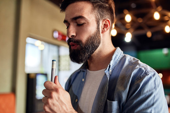 Portrait of man preparing his billiards cue