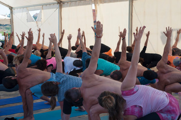 a lot of people do yoga hands up
