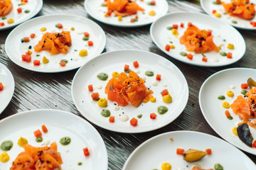Plates with sliced salmon, designer decorated cook.