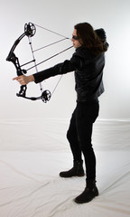 Mysterious man in black leather with compound bow