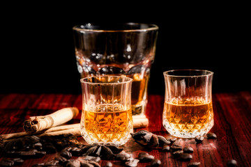 Brandy or liquor,Set of strong alcoholic drinks in glasses and shot glass on dark wood background