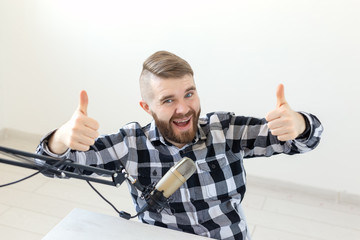 Radio host streamer and blogger concept - Man gesturing thum up over white background, host at...