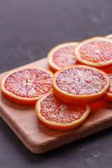 Blood orange cut in circles on a dark background
