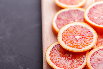 Blood orange cut in circles on a dark background